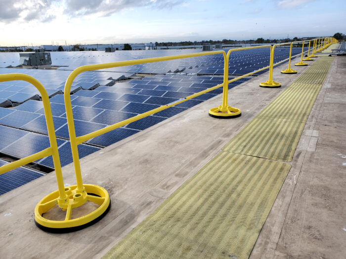 Mobile safety rails alongside a array of solar panels