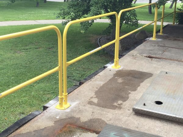 Permanent yellow safety railings on the top of a building overlooking landscape