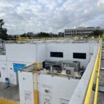 Parapet Wall Clamp holding rails on building ledge