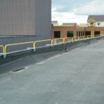 Parapet Wall Clamps being used on edge of rooftop